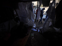 Palestinians inspect the site of an Israeli strike on tents of displaced people in Deir Al-Balah, Gaza Strip, on November 15, 2024. (