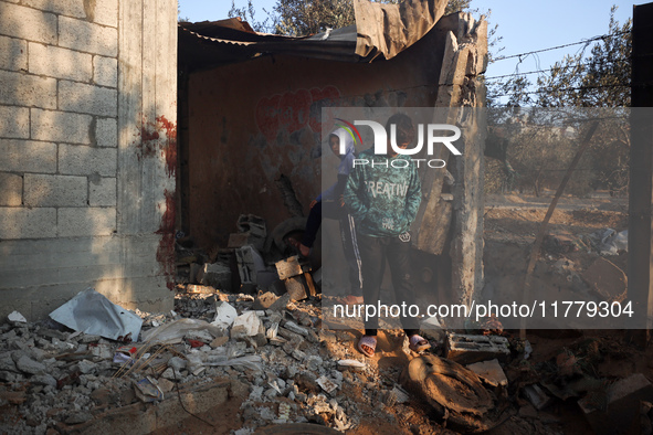 Palestinians inspect the site of an Israeli strike on tents of displaced people in Deir Al-Balah, Gaza Strip, on November 15, 2024. 