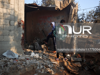 Palestinians inspect the site of an Israeli strike on tents of displaced people in Deir Al-Balah, Gaza Strip, on November 15, 2024. (