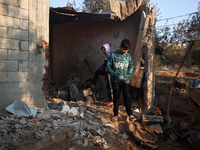 Palestinians inspect the site of an Israeli strike on tents of displaced people in Deir Al-Balah, Gaza Strip, on November 15, 2024. (