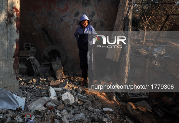 A Palestinian boy inspects the site of an Israeli strike on tents of displaced people in Deir Al-Balah, Gaza Strip, on November 15, 2024. 