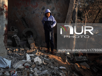 A Palestinian boy inspects the site of an Israeli strike on tents of displaced people in Deir Al-Balah, Gaza Strip, on November 15, 2024. (