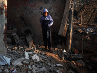 A Palestinian boy inspects the site of an Israeli strike on tents of displaced people in Deir Al-Balah, Gaza Strip, on November 15, 2024. (