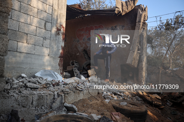 A Palestinian boy inspects the site of an Israeli strike on tents of displaced people in Deir Al-Balah, Gaza Strip, on November 15, 2024. 