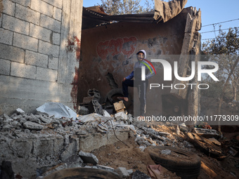 A Palestinian boy inspects the site of an Israeli strike on tents of displaced people in Deir Al-Balah, Gaza Strip, on November 15, 2024. (