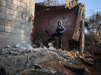 A Palestinian boy inspects the site of an Israeli strike on tents of displaced people in Deir Al-Balah, Gaza Strip, on November 15, 2024. (