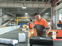 Workers work at the newly operational STO Express Hefei transit center in Hefei, China, on November 13, 2024. (