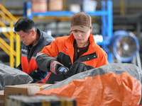 Workers work at the newly operational STO Express Hefei transit center in Hefei, China, on November 13, 2024. (