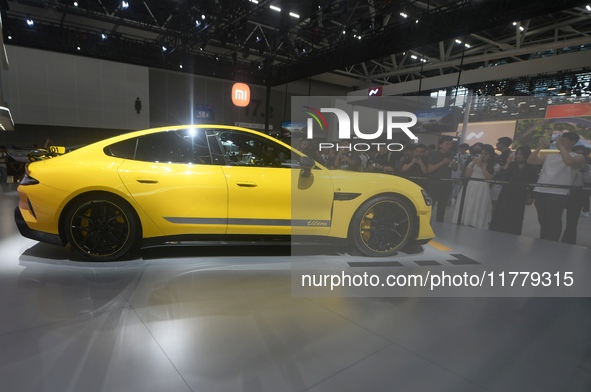 Visitors view a Xiaomi SU7 Ultra new energy vehicle at the 2024 Guangzhou Auto Show in Guangzhou, China, on November 15, 2024. 