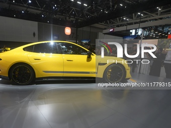 Visitors view a Xiaomi SU7 Ultra new energy vehicle at the 2024 Guangzhou Auto Show in Guangzhou, China, on November 15, 2024. (