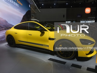 Visitors view a Xiaomi SU7 Ultra new energy vehicle at the 2024 Guangzhou Auto Show in Guangzhou, China, on November 15, 2024. (