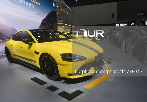 Visitors view a Xiaomi SU7 Ultra new energy vehicle at the 2024 Guangzhou Auto Show in Guangzhou, China, on November 15, 2024. 