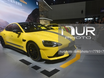 Visitors view a Xiaomi SU7 Ultra new energy vehicle at the 2024 Guangzhou Auto Show in Guangzhou, China, on November 15, 2024. (