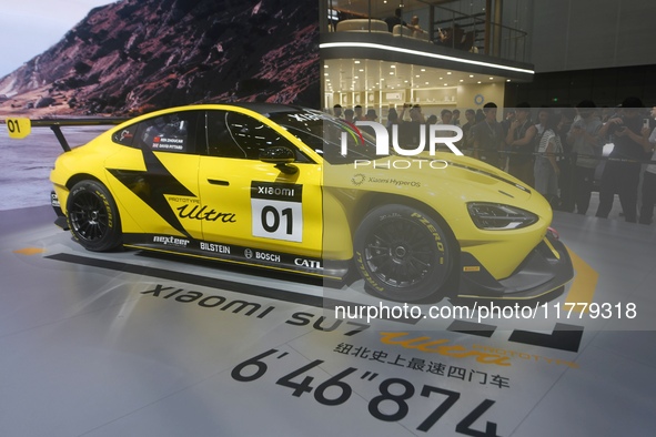 Visitors view a Xiaomi SU7 Ultra new energy vehicle at the 2024 Guangzhou Auto Show in Guangzhou, China, on November 15, 2024. 