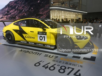 Visitors view a Xiaomi SU7 Ultra new energy vehicle at the 2024 Guangzhou Auto Show in Guangzhou, China, on November 15, 2024. (