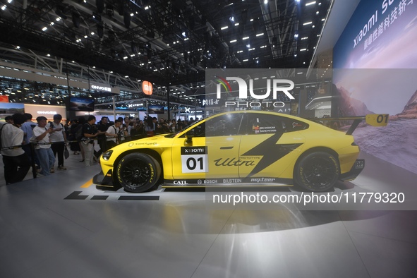 Visitors view a Xiaomi SU7 Ultra new energy vehicle at the 2024 Guangzhou Auto Show in Guangzhou, China, on November 15, 2024. 