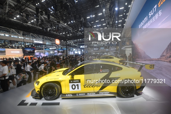 Visitors view a Xiaomi SU7 Ultra new energy vehicle at the 2024 Guangzhou Auto Show in Guangzhou, China, on November 15, 2024. 