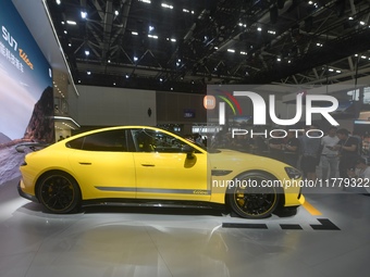 Visitors view a Xiaomi SU7 Ultra new energy vehicle at the 2024 Guangzhou Auto Show in Guangzhou, China, on November 15, 2024. (