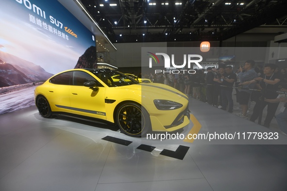 Visitors view a Xiaomi SU7 Ultra new energy vehicle at the 2024 Guangzhou Auto Show in Guangzhou, China, on November 15, 2024. 