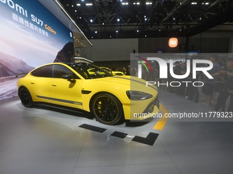 Visitors view a Xiaomi SU7 Ultra new energy vehicle at the 2024 Guangzhou Auto Show in Guangzhou, China, on November 15, 2024. (