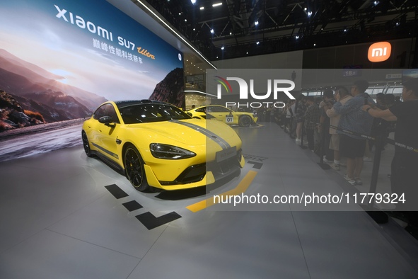 Visitors view a Xiaomi SU7 Ultra new energy vehicle at the 2024 Guangzhou Auto Show in Guangzhou, China, on November 15, 2024. 