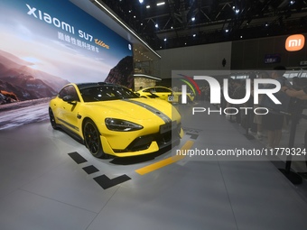 Visitors view a Xiaomi SU7 Ultra new energy vehicle at the 2024 Guangzhou Auto Show in Guangzhou, China, on November 15, 2024. (