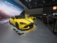 Visitors view a Xiaomi SU7 Ultra new energy vehicle at the 2024 Guangzhou Auto Show in Guangzhou, China, on November 15, 2024. (