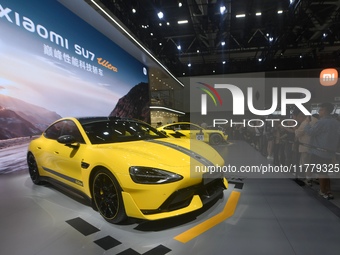 Visitors view a Xiaomi SU7 Ultra new energy vehicle at the 2024 Guangzhou Auto Show in Guangzhou, China, on November 15, 2024. (