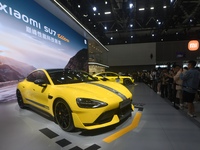 Visitors view a Xiaomi SU7 Ultra new energy vehicle at the 2024 Guangzhou Auto Show in Guangzhou, China, on November 15, 2024. (