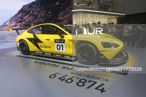 Visitors view a Xiaomi SU7 Ultra new energy vehicle at the 2024 Guangzhou Auto Show in Guangzhou, China, on November 15, 2024. 