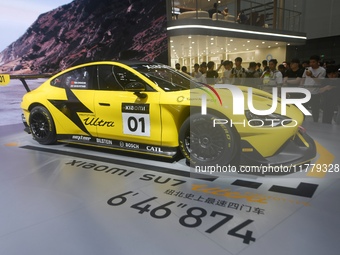 Visitors view a Xiaomi SU7 Ultra new energy vehicle at the 2024 Guangzhou Auto Show in Guangzhou, China, on November 15, 2024. (