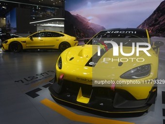 Visitors view a Xiaomi SU7 Ultra new energy vehicle at the 2024 Guangzhou Auto Show in Guangzhou, China, on November 15, 2024. (