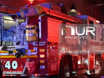 FDNY firefighters respond to a commercial high-rise fire on West 48th Street in Manhattan, New York, United States, on November 15, 2024. Th...