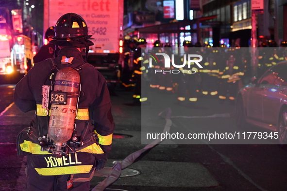 FDNY firefighters respond to a commercial high-rise fire on West 48th Street in Manhattan, New York, United States, on November 15, 2024. Th...