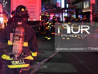 FDNY firefighters respond to a commercial high-rise fire on West 48th Street in Manhattan, New York, United States, on November 15, 2024. Th...