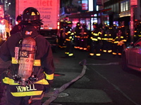 FDNY firefighters respond to a commercial high-rise fire on West 48th Street in Manhattan, New York, United States, on November 15, 2024. Th...