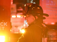 FDNY firefighters respond to a commercial high-rise fire on West 48th Street in Manhattan, New York, United States, on November 15, 2024. Th...