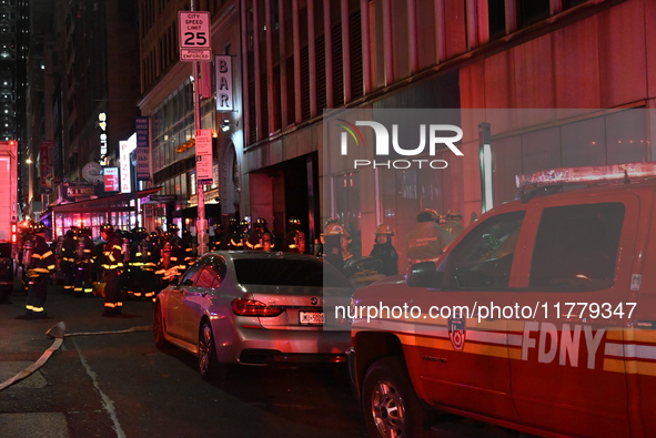 FDNY firefighters respond to a commercial high-rise fire on West 48th Street in Manhattan, New York, United States, on November 15, 2024. Th...