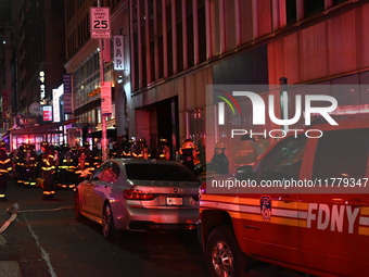 FDNY firefighters respond to a commercial high-rise fire on West 48th Street in Manhattan, New York, United States, on November 15, 2024. Th...