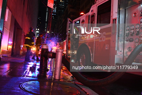 FDNY firefighters respond to a commercial high-rise fire on West 48th Street in Manhattan, New York, United States, on November 15, 2024. Th...