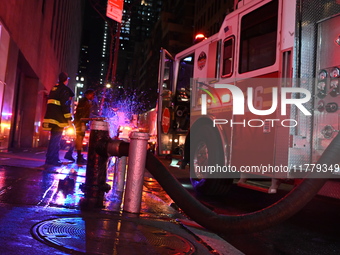 FDNY firefighters respond to a commercial high-rise fire on West 48th Street in Manhattan, New York, United States, on November 15, 2024. Th...