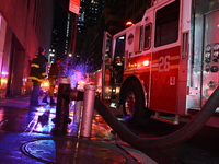 FDNY firefighters respond to a commercial high-rise fire on West 48th Street in Manhattan, New York, United States, on November 15, 2024. Th...