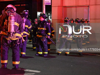 FDNY firefighters respond to a commercial high-rise fire on West 48th Street in Manhattan, New York, United States, on November 15, 2024. Th...