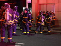 FDNY firefighters respond to a commercial high-rise fire on West 48th Street in Manhattan, New York, United States, on November 15, 2024. Th...