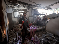 A Palestinian man inspects the site of an Israeli strike on a house in Deir Al-Balah in the central Gaza Strip on November 15, 2024. (