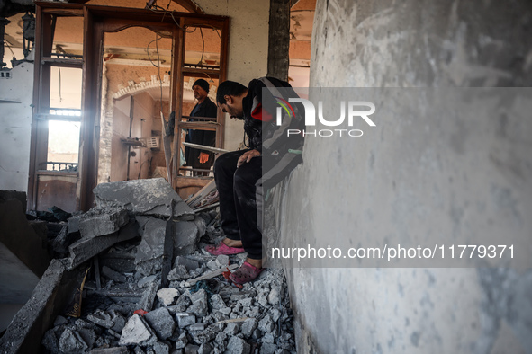 Palestinians inspect the site of an Israeli strike on a house in Deir Al-Balah in the central Gaza Strip on November 15, 2024. 