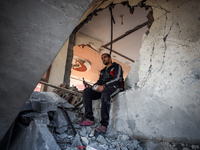 A Palestinian man inspects the site of an Israeli strike on a house in Deir Al-Balah in the central Gaza Strip on November 15, 2024. (