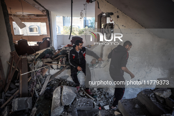 Palestinians inspect the site of an Israeli strike on a house in Deir Al-Balah in the central Gaza Strip on November 15, 2024. 