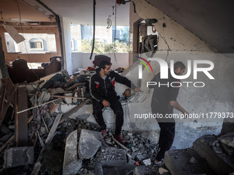 Palestinians inspect the site of an Israeli strike on a house in Deir Al-Balah in the central Gaza Strip on November 15, 2024. (