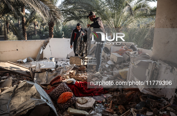 Palestinians inspect the site of an Israeli strike on a house in Deir Al-Balah in the central Gaza Strip on November 15, 2024. 